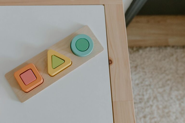 Simple wooden geometric toys on a textured table, ideal for child education imagery.